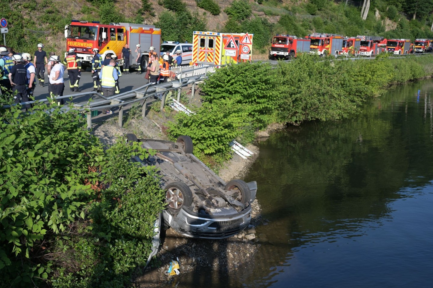 Rettungskräfte arbeiten an der Unfallstelle am Fluss Lenne.